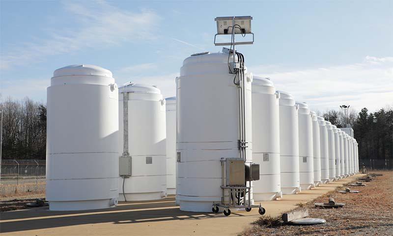The High Burnup Research Cask (center) stands with other spent nuclear fuel dry storage casks at North Anna Power Station in Virginia. Dominion Energy